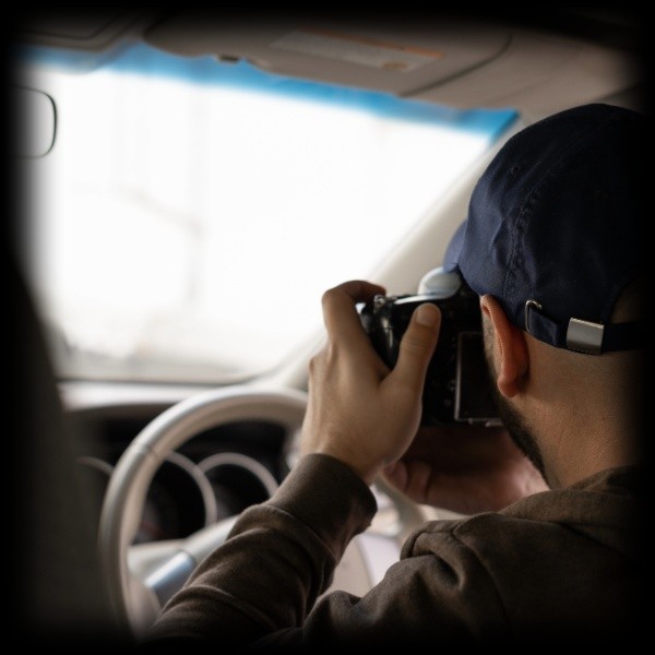 a surveillance agent taking a photograph